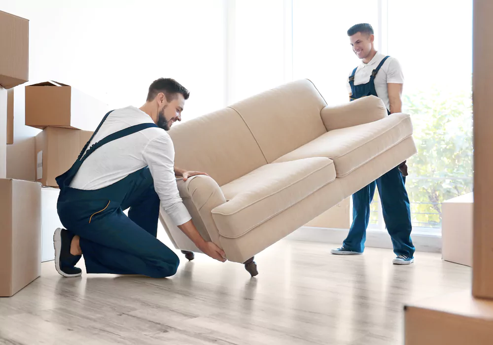 Two movers lifting sofa during the move.